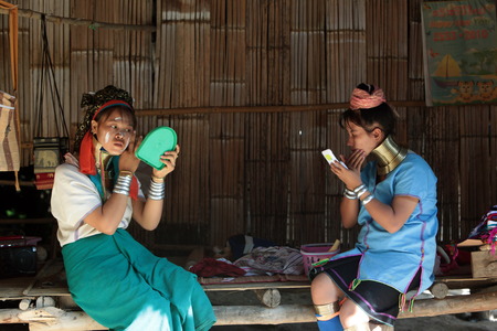 A traditionally dressed wife of a long-necked Paudang tribe from Burma living in a village north of Chiang Mai in northern Thailandのeditorial素材