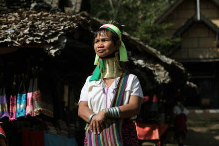 A traditionally dressed wife of a long-necked Paudang tribe from Burma living in a village north of Chiang Mai in northern Thailandのeditorial素材
