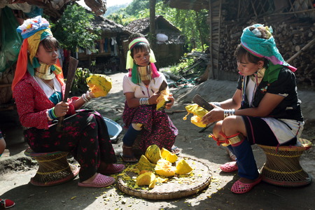 A traditionally dressed wife of a long-necked Paudang tribe from Burma living in a village north of Chiang Mai in northern Thailandのeditorial素材
