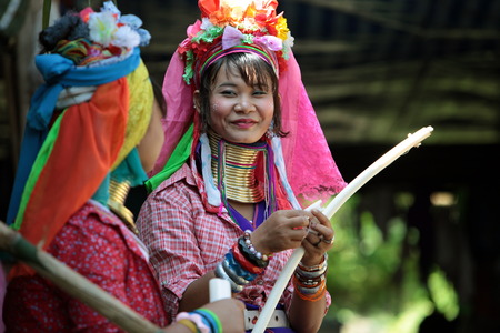 A traditionally dressed wife of a long-necked Paudang tribe from Burma living in a village north of Chiang Mai in northern Thailandのeditorial素材