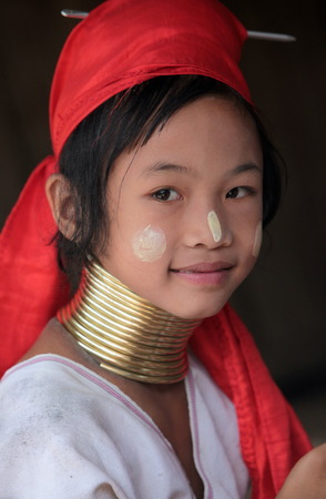 A traditionally dressed wife of a long-necked Paudang tribe from Burma living in a village north of Chiang Mai in northern Thailandのeditorial素材