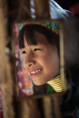 A traditionally dressed wife of a long-necked Paudang tribe from Burma living in a village north of Chiang Mai in northern Thailandのeditorial素材