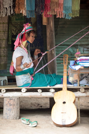 A Traditionally dressed wife of a long-necked Paudang tribe from Burma living in a village north of Chiang Mai in northern Thailandのeditorial素材