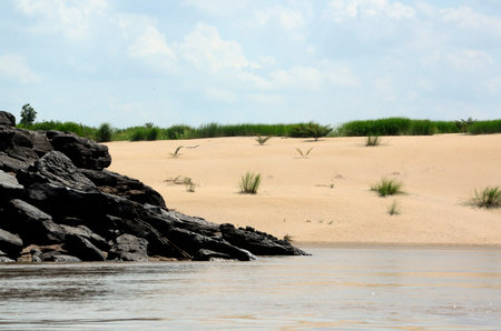 The stone landscape with a sandy beach in the Mekong River at the Nature Park Sam Phan Bok at Lakhon Pheng on the Mekong River in the province of Amnat Charoen north-west of Ubon Ratchathani in the northeast of Thailand in South East Asiaの写真素材