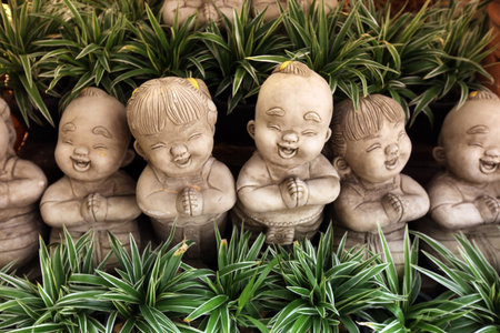 Small Figures in a garden of old Sukhothai Province Sukhothai in the north of Thailand in South East Asiaの写真素材