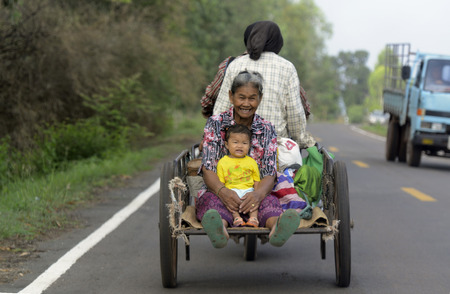 A motorcycle with a trailer on a highway in the province of Amnat Charoen north-west of Ubon Ratchathani in the northeast of Thailand in South East Asiaのeditorial素材