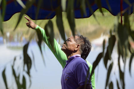 People watching a rocket launch at traditioellen Bun Bang Fai Rocket Festival or or Rocket Festival in Ban Si Than in the province Amnat Charoen north-west of Ubon Ratchathani in the northeast of Thailand in South East Asiaのeditorial素材