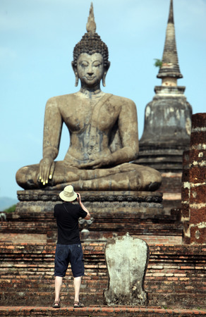 A Buddha statue in Wat Mahathat temple in the temple complex of Old Sukhothai Province Sukhothai in the north of Thailand in South East Asiaのeditorial素材