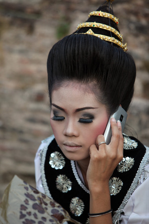 Dancers a traditional dance group prepares for a show in front of Wat Sa Si temple in the temple complex of Old Sukhothai Province Sukhothai in the north of Thailand in South East Asiaのeditorial素材