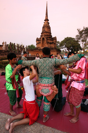 Dancers a traditional dance group prepares for a show in front of Wat Sa Si temple in the temple complex of Old Sukhothai Province Sukhothai in the north of Thailand in South East Asiaのeditorial素材