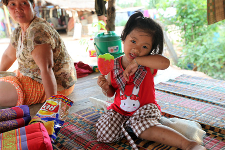 A child with an ice cream in the provincial capital Amnat Charoen province Amnat Charoen in Isan in the northeast of Thailandのeditorial素材