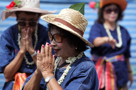 A traditional dance group with the Thai Greet shows at the festival parade at the Bun Bang Fai Rocket Festival in Yasothon or in Isan in the northeast of Thailandのeditorial素材