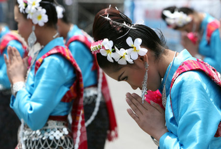 A traditional dance group with the Thai Greet shows at the festival parade at the Bun Bang Fai Rocket Festival in Yasothon or in Isan in the northeast of Thailandのeditorial素材