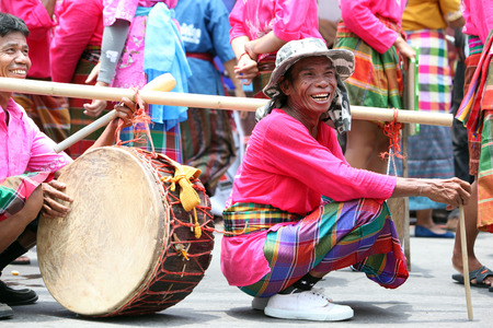 A musician of a traditional dance group shows at the festival parade at the Bun Bang Fai Rocket Festival in Yasothon or in Isan in the northeast of Thailandのeditorial素材