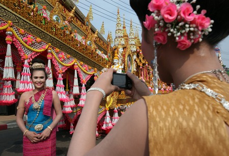 People in front of Big rocket on the decorated rocket car at the parade at the Bun Bang Fai festival or Rocket Festival in Yasothon in Isan in the northeast of Thailandのeditorial素材