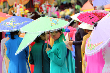 People with paper umbrellas at the festival parade at the Bun Bang Fai Rocket Festival in Yasothon or in Isan in the northeast of Thailandのeditorial素材