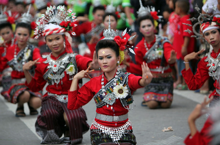 A traditional dance group shows at the festival parade at the Bun Bang Fai Rocket Festival in Yasothon or in Isan in the northeast of Thailandのeditorial素材