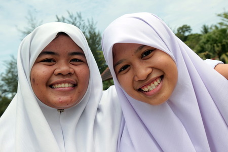 Two schoolgirls in uniform in the capital Bandar Seri Begawan in Brunei Darussalam Kingdom on Borneo in South East Asiaのeditorial素材