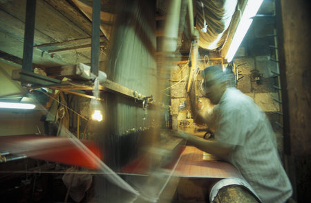 A carpet weaving in the Souq or market in the medina of the old city of Aleppo in northern Syria in the Middle Eastのeditorial素材
