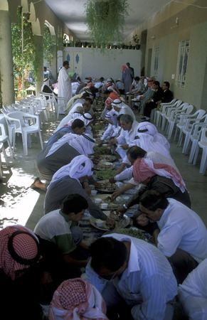 Syrian Einwohener while eating at a wedding feast in the historic center of the town Bosra in the south of Syria in the Middle Eastのeditorial素材