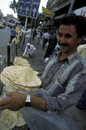 A man let dry cooperation of pita bread in the Old City of Aleppo in northern Syria in the Middle Eastのeditorial素材