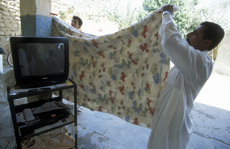A family with a television at Abu Kamal on the border with Iraq in the east of Syriaのeditorial素材