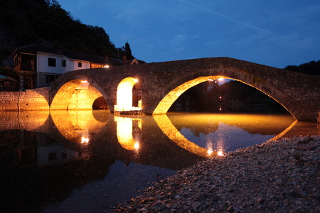 The landscape with the stone bridge from Rijeka Rijeka crnojevica crnojevica with the river at the western end of the Skadar Lake Skadar Jezero lake or in central Montenegro in Montenegro in the Balkans, the Mediterranean Sea in Europeの写真素材