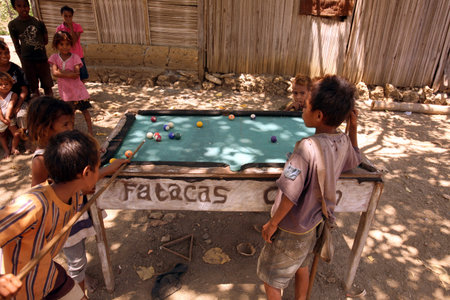 Children playing billiards at Hato-Udo in sueden of East Timor on the island of Timor separated into...