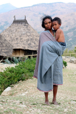 A girl with a baby in a farming village in the mountain village of Maubisse south of Dili in East Timor on the island of Timor separated into two in Asiaのeditorial素材