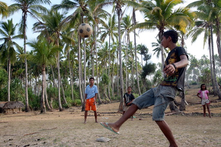 Children at play football at Viqueque in East Timor on the Zental in two separate island of Timor in Asiaのeditorial素材