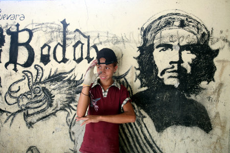 A boy in front of a Che image in Uatolari at the south-east coast of Timor on the island of Timor separated into two in Asiaのeditorial素材