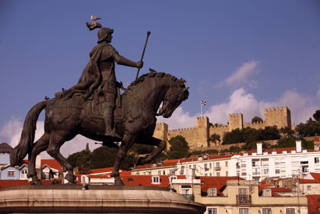 The equestrian monument on the Praca da Figuera with the castle in the city center of the capital city of Lisbon in Portugalのeditorial素材
