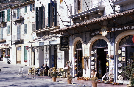 The fishing village of Port de Soler with the promenade near the fishing harbor in February in the north of the island of the Balearic Islands in the Mediterraneanのeditorial素材