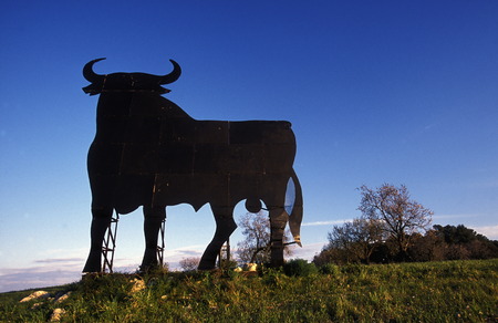 A billboard with a Spanish bull stands in the Landscahft in the center of the island of Mallorca Balearic Islands one of the islands in the Mediterraneanのeditorial素材