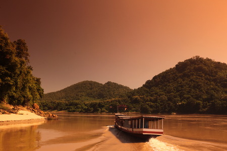 A boat on the Mekong River at Luang Prabang in Central Laos Laos in South East Asiaの写真素材