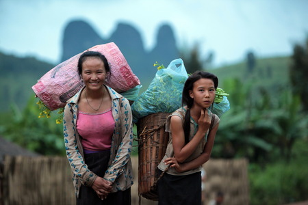 People in the countryside in the mountain region near the village of Kasi at the national highway 13 between Vang Vieng and Luang Prabang in Laos of Central Laos in South East Asiaのeditorial素材
