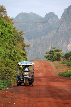 The Road 12 near the village of Tham Pa Fa Mahaxai May from near the town of Tha Khaek in central Laos on the border with Thailand in Southeast Asiaのeditorial素材