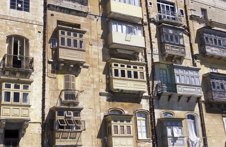 The traditional Balconys on the Houses in the Old Town of the city of Valletta on the Island of Malta in the Mediterranean Sea in Europe.のeditorial素材