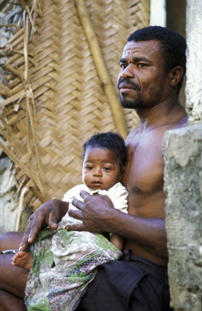 a men with his child in the city of Moutsamudu on the Iceland of Anjouan on the Comoros in the Indian Ocean Ilands in Africa.のeditorial素材