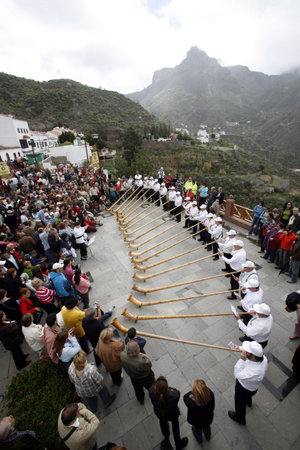 Swiss Alphorn player in the mountain village of Tejeda in the center of the Canary Iceland of Spain...