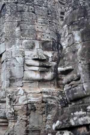 Stone Faces the Tempel Ruin of Angkor Thom in the Temple City of Angkor near the City of Siem Riep in the west of Cambodia.のeditorial素材