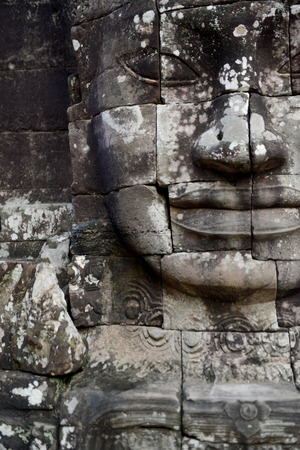 Stone Faces the Tempel Ruin of Angkor Thom in the Temple City of Angkor near the City of Siem Riep in the west of Cambodia.のeditorial素材