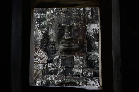Stone Faces the Tempel Ruin of Angkor Thom in the Temple City of Angkor near the City of Siem Riep in the west of Cambodia.のeditorial素材
