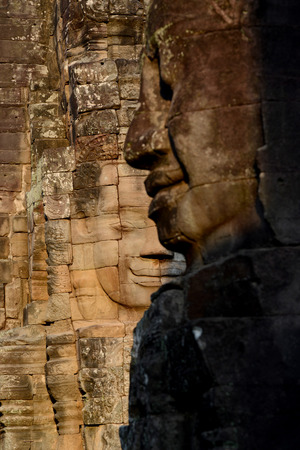 Stone Faces the Tempel Ruin of Angkor Thom in the Temple City of Angkor near the City of Siem Riep in the west of Cambodia.のeditorial素材