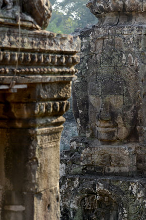 Stone Faces the Tempel Ruin of Angkor Thom in the Temple City of Angkor near the City of Siem Riep in the west of Cambodia.のeditorial素材
