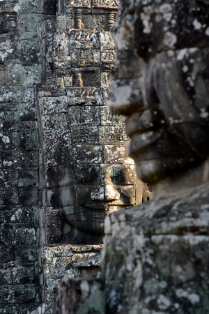 Stone Faces the Tempel Ruin of Angkor Thom in the Temple City of Angkor near the City of Siem Riep in the west of Cambodia.のeditorial素材