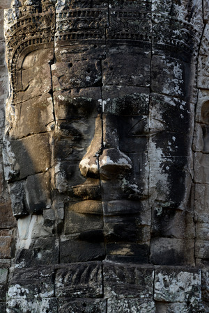 Stone Faces the Tempel Ruin of Angkor Thom in the Temple City of Angkor near the City of Siem Riep in the west of Cambodia.のeditorial素材