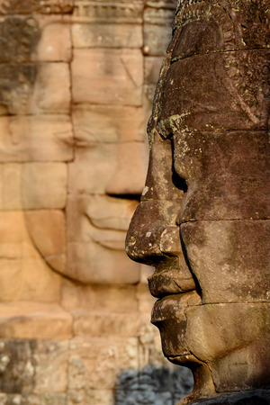 Stone Faces the Tempel Ruin of Angkor Thom in the Temple City of Angkor near the City of Siem Riep in the west of Cambodia.のeditorial素材