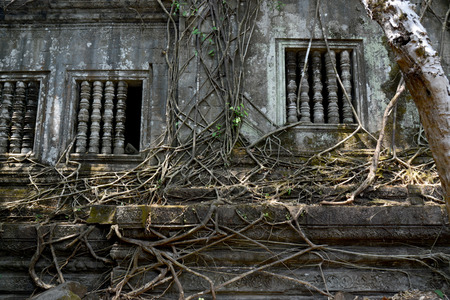 Stone Faces the Tempel Ruin of Angkor Thom in the Temple City of Angkor near the City of Siem Riep in the west of Cambodia.のeditorial素材