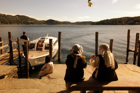 The island Isola San Giulio Orta in front of the old town of the traditional fishing village of Orta Lake Orta in the north of the Piedmont in the north of Italy. (Urs Flüeler)のeditorial素材